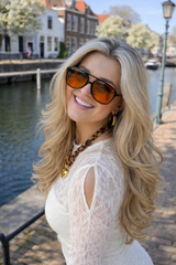 Model wearing black frame orange lens sunglasses side view